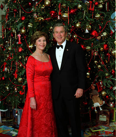 Arnold Scaasi designed red dress worn by Laura Bush for a Dec. 7, 2003 portrait with President George W. Bush in front of the White House Christmas Tree. Courtesy of the George W. Bush Presidential Library and Museum. White House photo by Eric Draper. 