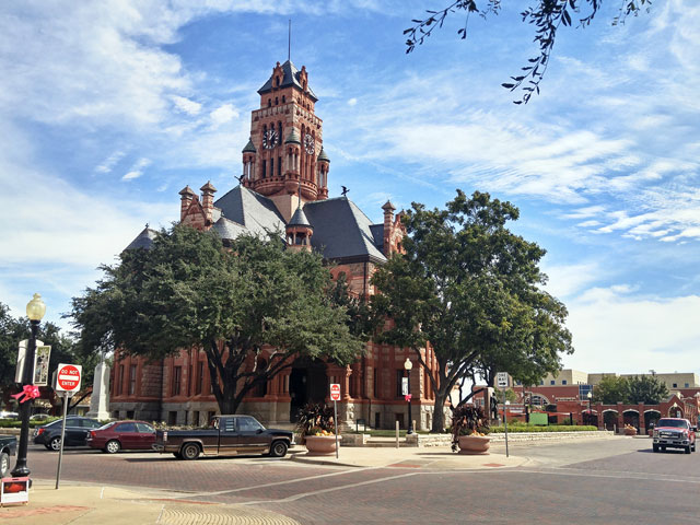 The historic 1894 Ellis County Courthouse sits at the center of Waxahachie's picturesque downtown area.