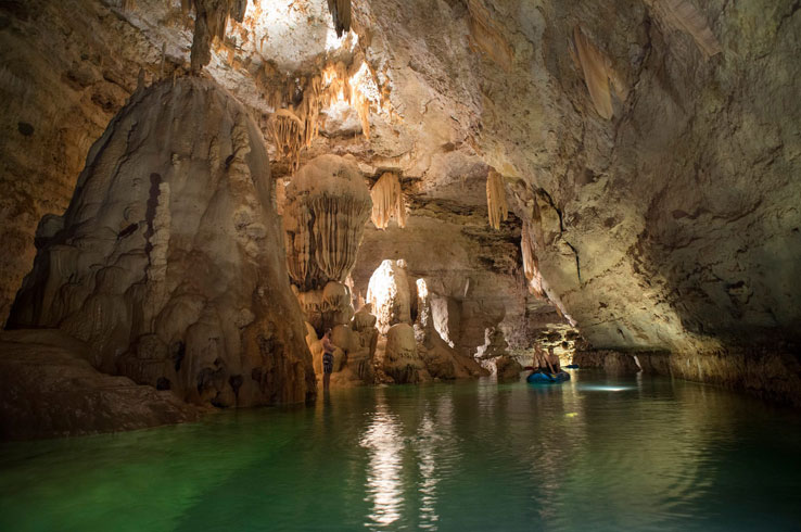 Two cave visitors float down an underwater pool in Natural Bridge Caverns.