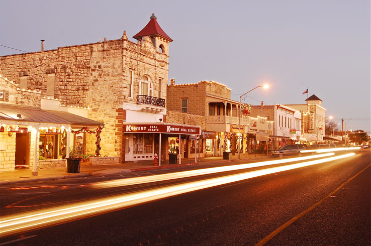 A nighttime view of the historic buildings along Fredericksburg's Haupstrasse, or Main Street.