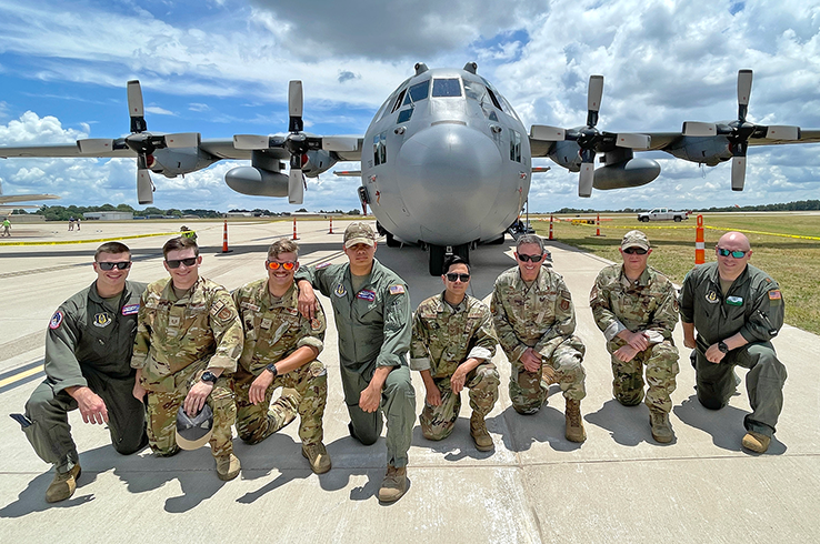 Pilots posing in front of a large airplane