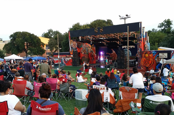 A crowd in lawn chairs watches a performance at the Hillside Theater in Pan American Neighborhood Park during the Pan Am Summer Hillside Concert Series in East Austin.