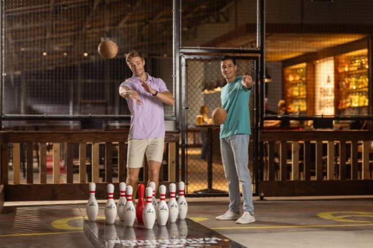 Two men playing at the Fowling Warehouse in Plano