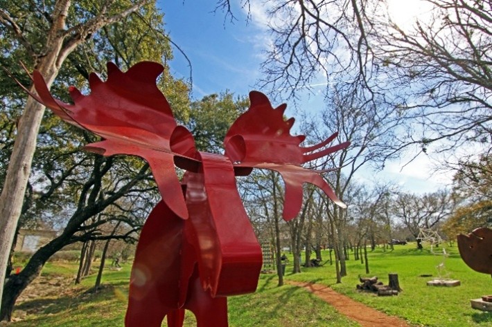 Red metal moose sculpture in Salado