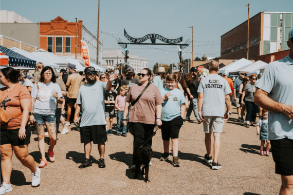 Crowds walking a downtown festival in the Arts & Historic District