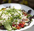 Mixed Greens with Heirloom Tomatoes, Pesto Dressing and Pine Nuts